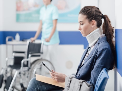 a woman in a neck brace visiting the doctor's office