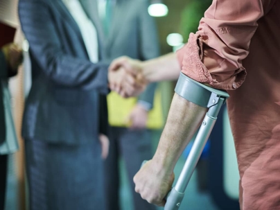 a man using crutches shaking hands