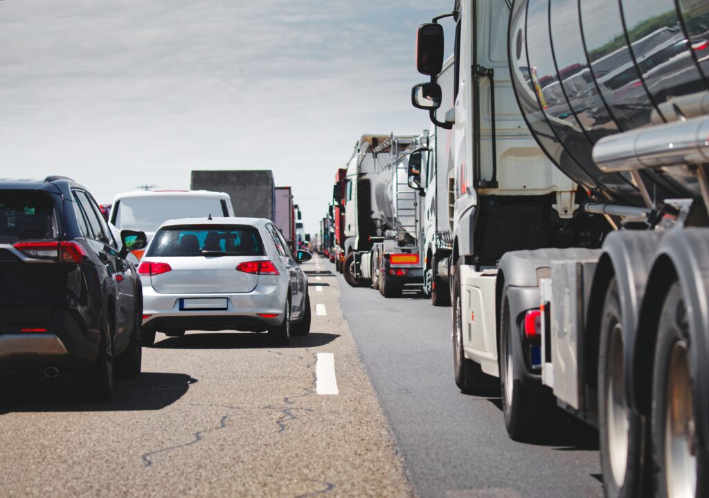 Cars and trucks in traffic congestion on highway
