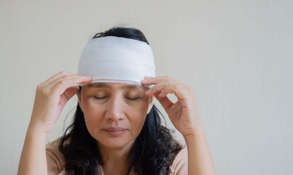 Injured woman with bandage on head