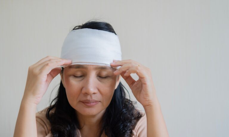 Injured woman with bandage on head