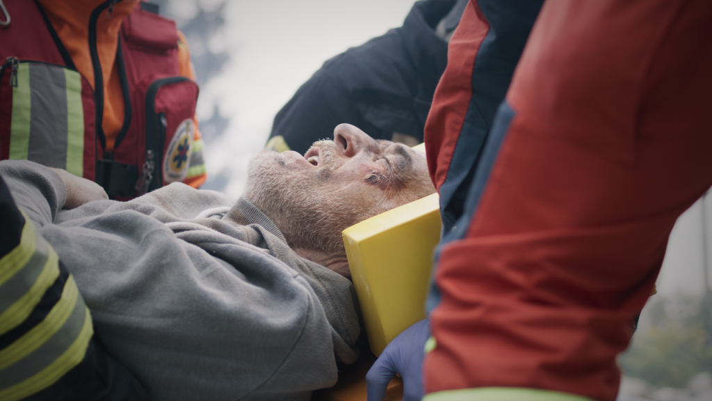 Paramedics carrying catastrophically injured man after accident